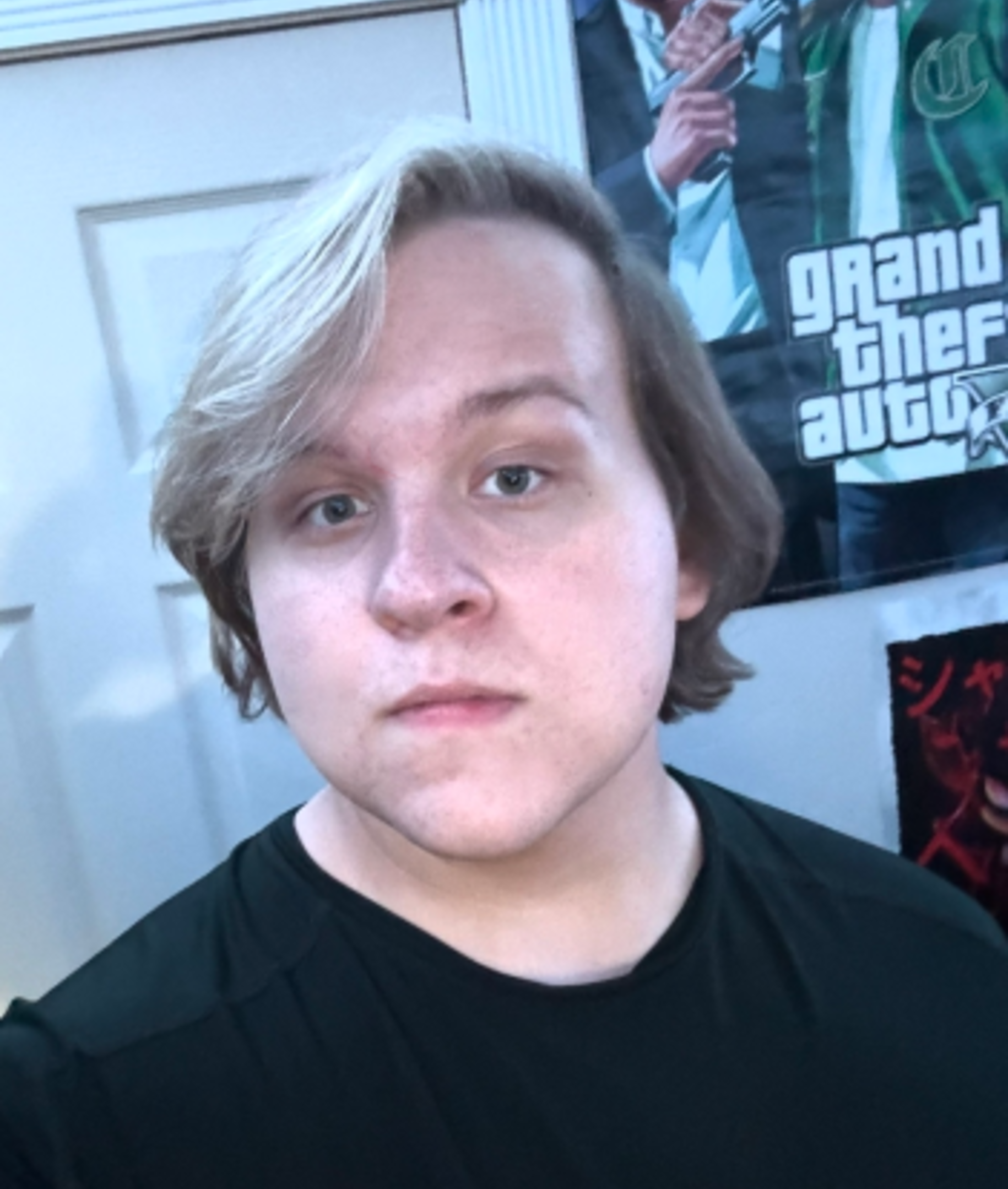 Portrait of Rylee Simpson with light blonde hair and a black shirt, under purple-tinted indoor lighting.